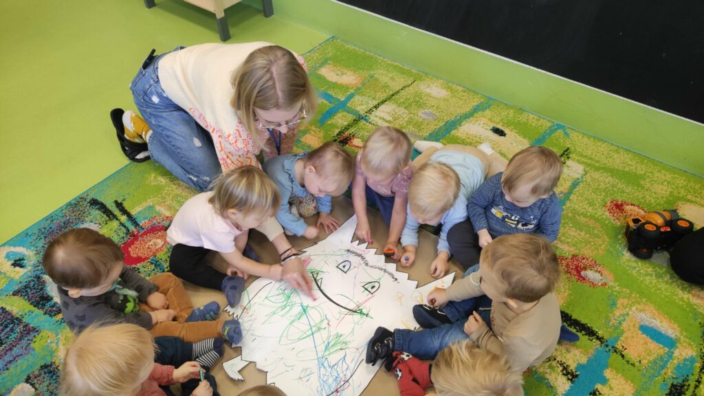 Dzieci malują kolorowego potworka podczas zajęć z emocji.
